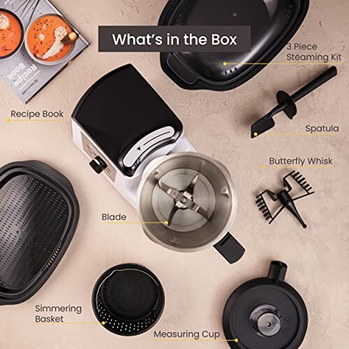 Contents of a kitchen appliance box including a recipe book, blade, simmering basket, measuring cup, butterfly whisk, spatula, and 3-piece steaming kit.