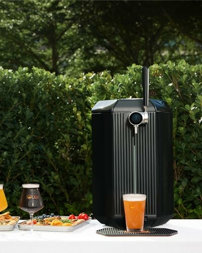 Outdoor beer dispenser with glasses and food on a table.